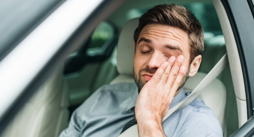 Tired man in a car.